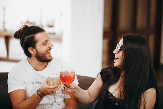 persons on dating drinking and smiling