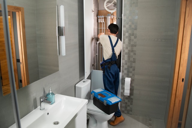 a-plumber-repairs-plumbing-in-a-bathroom